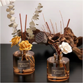 The Coastal Ritual aromatherapy reed diffuser duo with natural rattan reeds, styled side by side